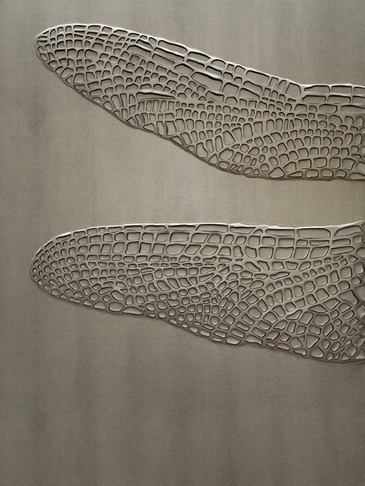 Detail of hand-sculpted dragonfly artwork in steel colour shagreen textured faux leather and matching colour aluminium frame